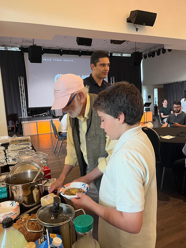 Professor Cooks gets food from the buffet table.